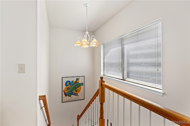 staircase featuring a notable chandelier