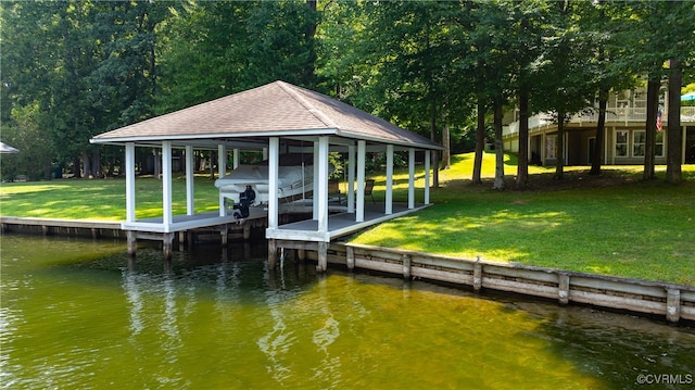 view of dock featuring a yard, a water view, and boat lift