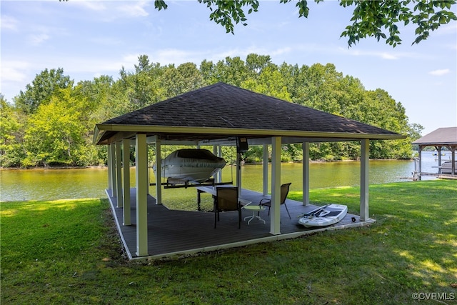 view of community with a lawn, a water view, and a boat dock