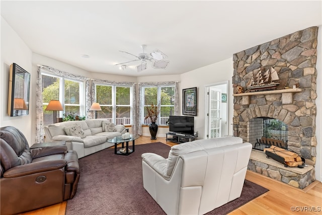 living room with ceiling fan, a fireplace, and hardwood / wood-style floors