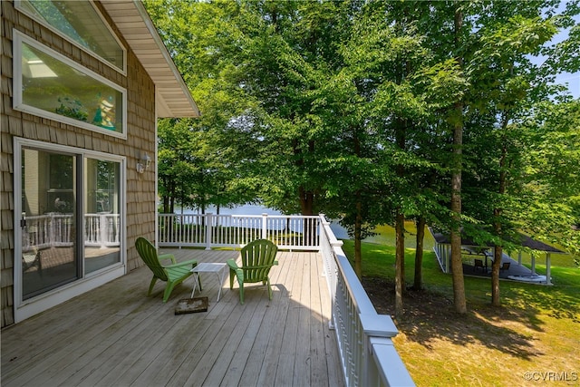 wooden terrace featuring a yard