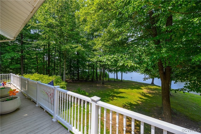 wooden terrace with a lawn and a water view