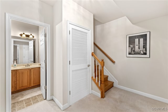 staircase with carpet floors and sink