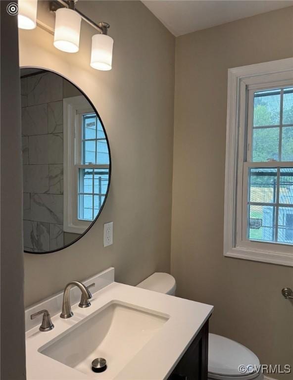 bathroom with toilet and vanity