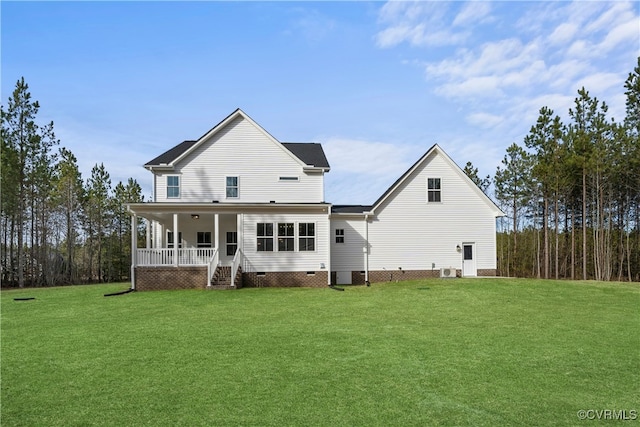 rear view of house featuring a porch and a lawn