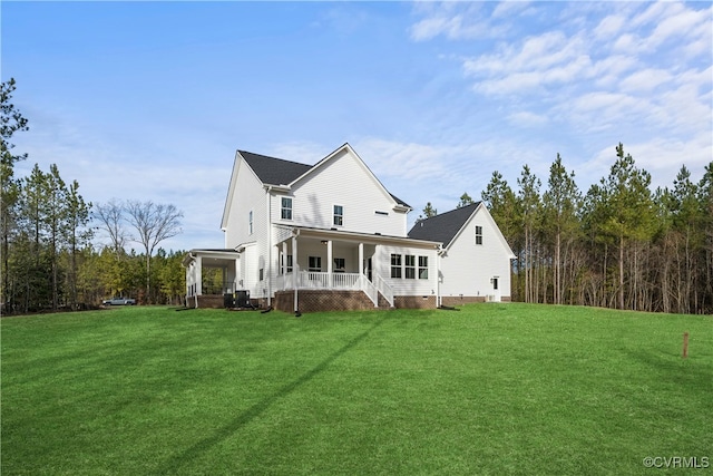 rear view of property featuring a porch and a yard