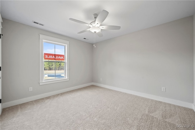 spare room featuring ceiling fan and carpet