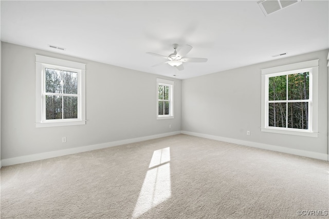 carpeted spare room featuring ceiling fan