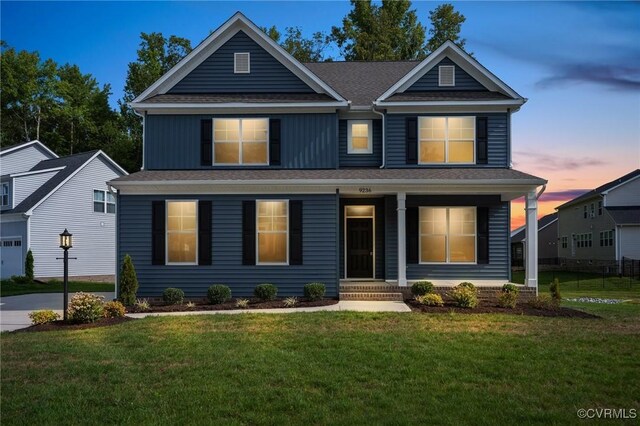 view of front of house with a garage and a yard