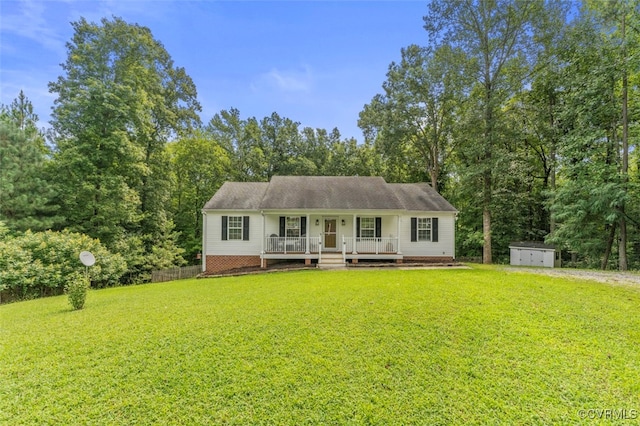 view of front of home featuring a porch, a front yard, and a storage unit