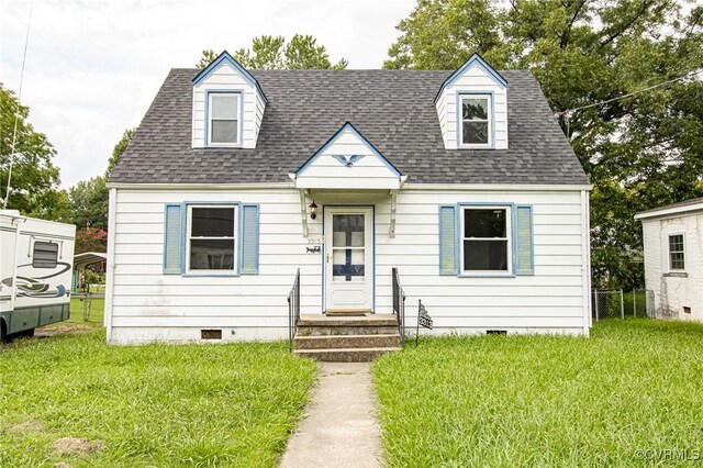 new england style home with a front lawn