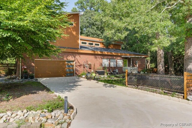 view of front of property with a porch and a garage