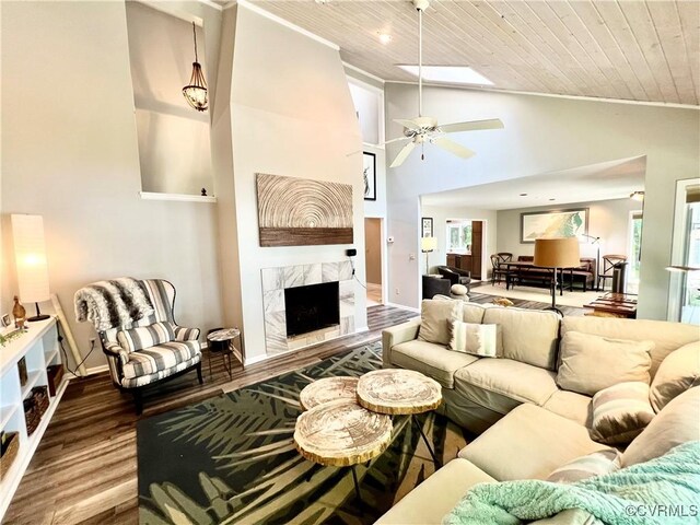 living room with high vaulted ceiling, a fireplace, hardwood / wood-style flooring, ceiling fan, and wood ceiling