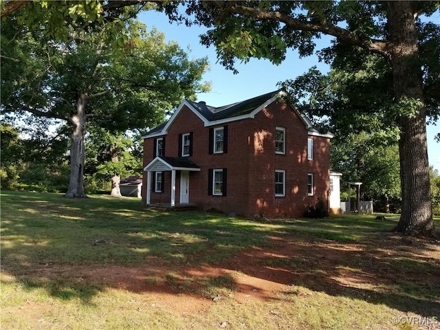 view of home's exterior featuring a lawn and brick siding