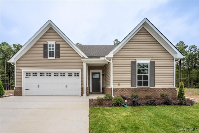 view of front of home with a front yard, brick siding, and driveway