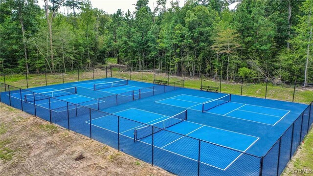 view of tennis court with fence