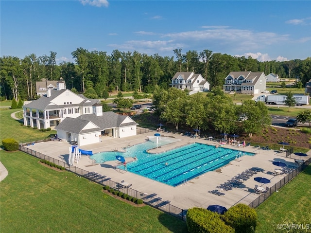 pool with a yard, fence, and a patio