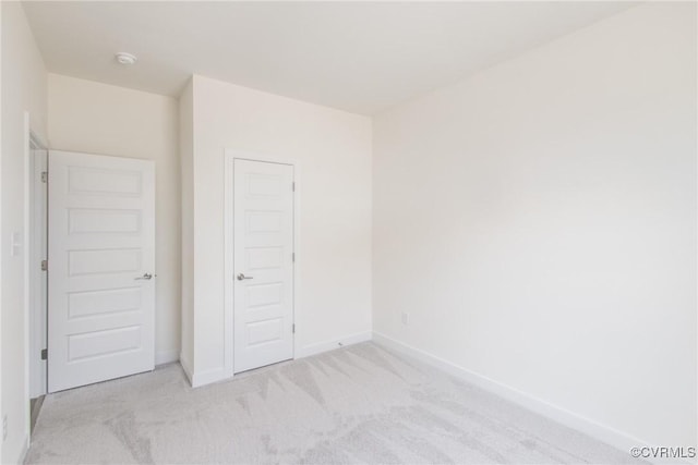 unfurnished bedroom featuring carpet flooring and baseboards