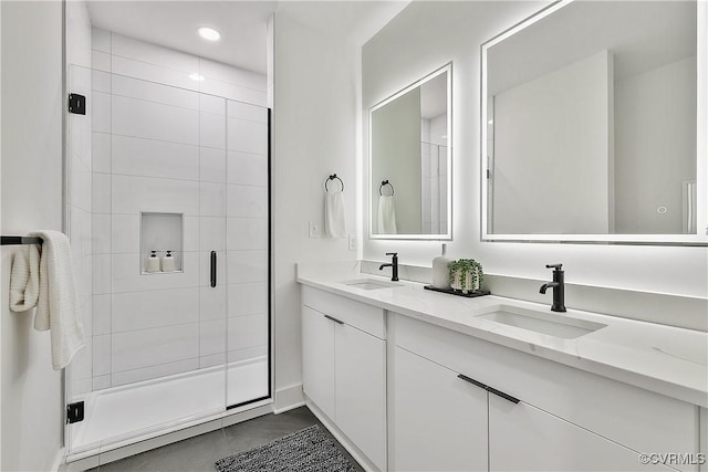 bathroom featuring vanity, tile patterned floors, and a shower with shower door