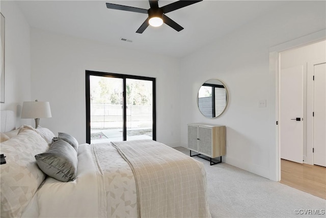 bedroom featuring ceiling fan, light carpet, and access to outside