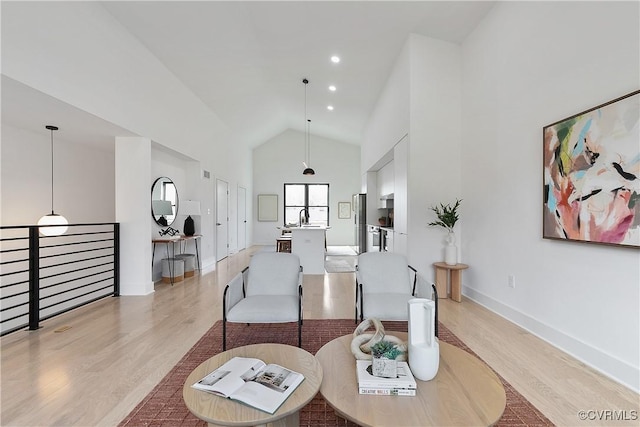 living room featuring light hardwood / wood-style flooring and high vaulted ceiling