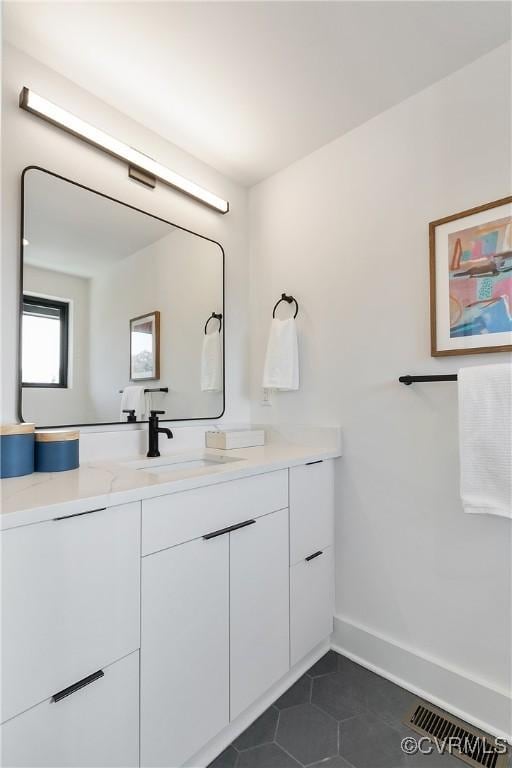 bathroom featuring tile patterned flooring and vanity