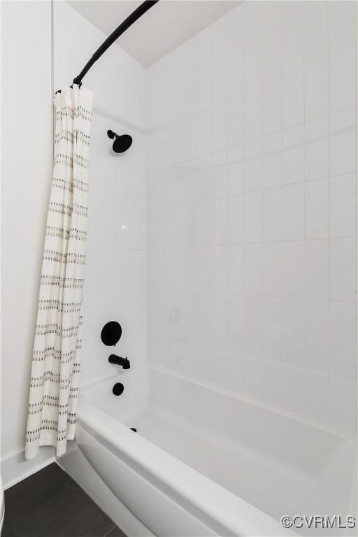 bathroom with shower / tub combo with curtain