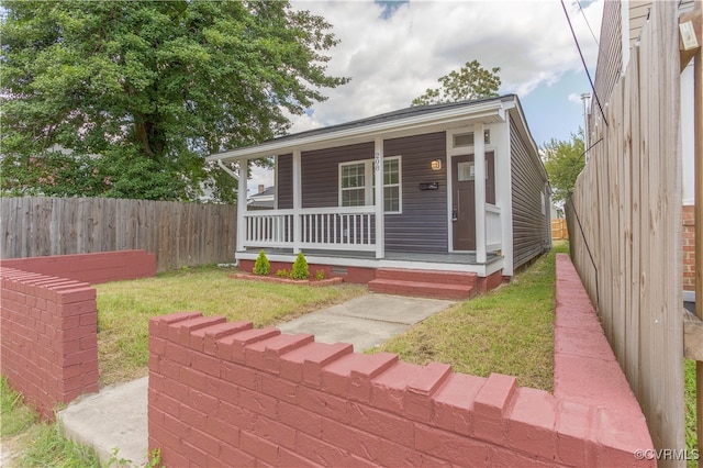 view of front of house with a front lawn and a porch