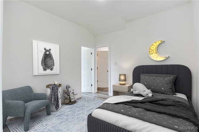 bedroom featuring vaulted ceiling and hardwood / wood-style flooring