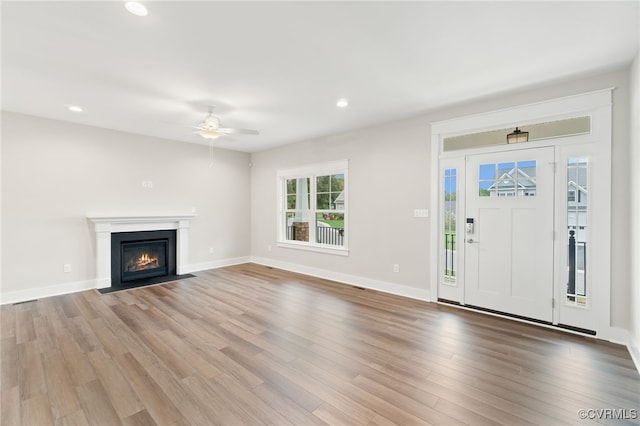 foyer with hardwood / wood-style floors and ceiling fan