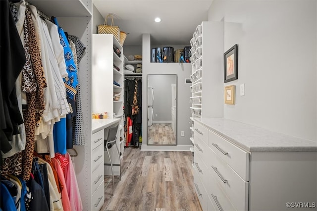 walk in closet featuring light hardwood / wood-style floors