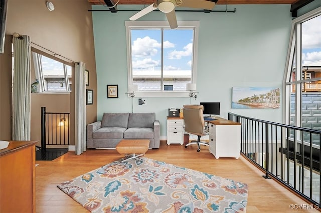 office space with a healthy amount of sunlight, ceiling fan, and light wood-type flooring