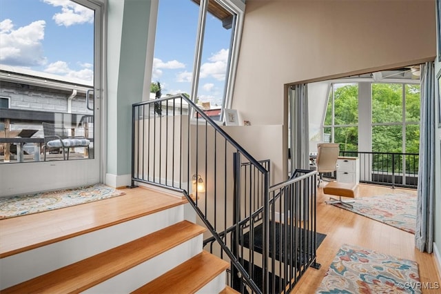 stairs featuring hardwood / wood-style floors