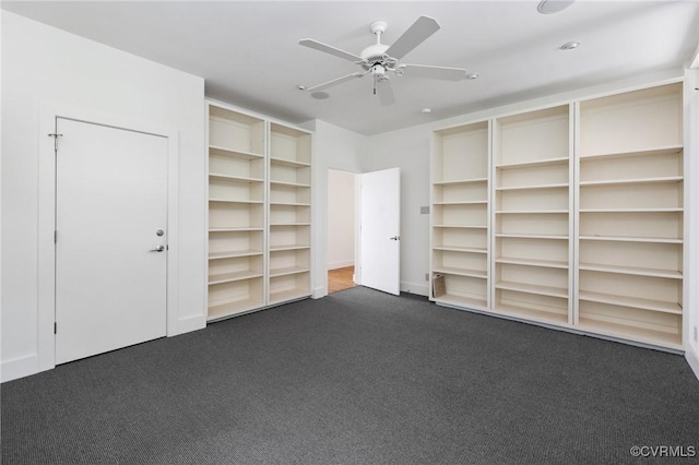 interior space featuring dark colored carpet and ceiling fan