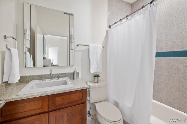 full bathroom with shower / bathtub combination with curtain, vanity, and toilet