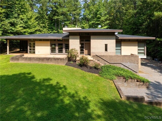 view of front of home with a front lawn and a patio area