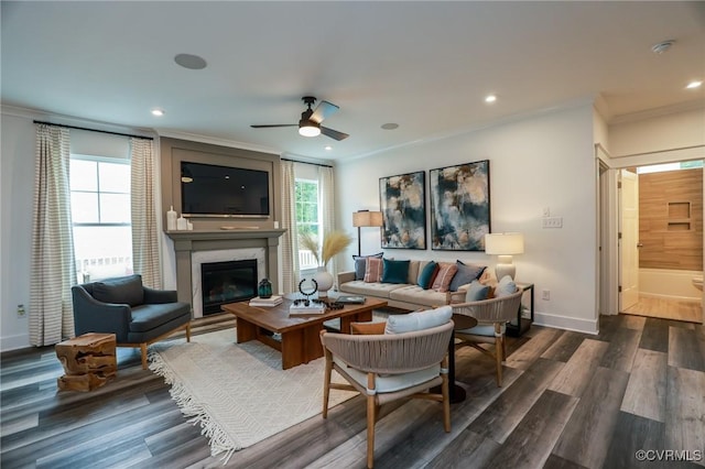 living room featuring ornamental molding, wood finished floors, recessed lighting, a premium fireplace, and baseboards