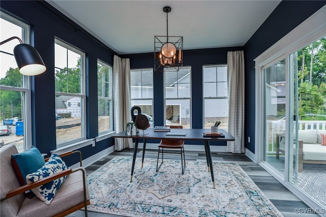 office area featuring a wealth of natural light, an inviting chandelier, and hardwood / wood-style floors