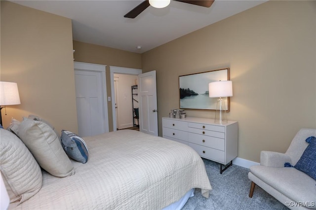 carpeted bedroom featuring baseboards and ceiling fan