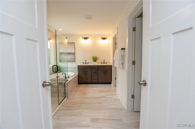 bathroom featuring separate shower and tub, vanity, and tile patterned floors