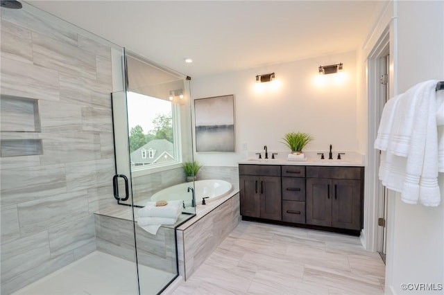 bathroom with a sink, double vanity, a bath, and a shower stall