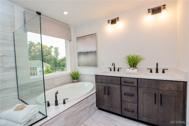 bathroom with tile patterned flooring, independent shower and bath, and vanity