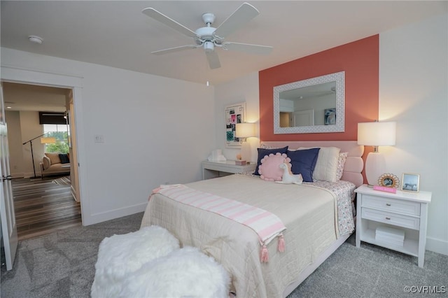 carpeted bedroom featuring a ceiling fan and baseboards