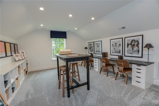 office space featuring light colored carpet and vaulted ceiling