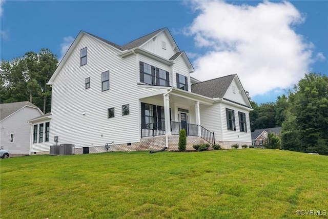 view of front facade with a porch, cooling unit, a front yard, and crawl space