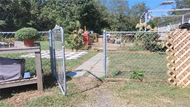 view of gate with a lawn