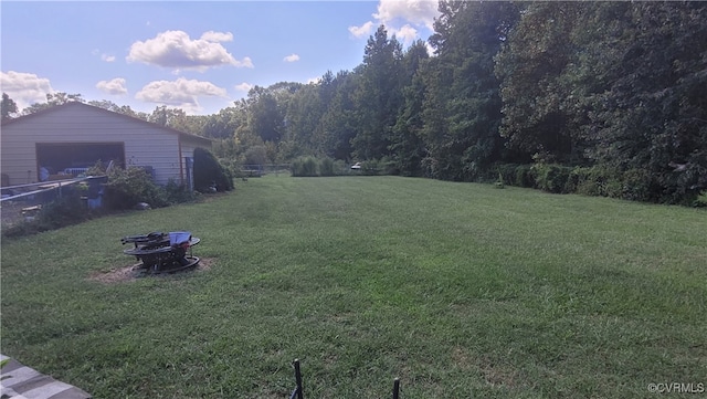 view of yard with an outdoor structure and a fire pit