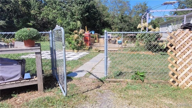 view of gate with a yard and fence