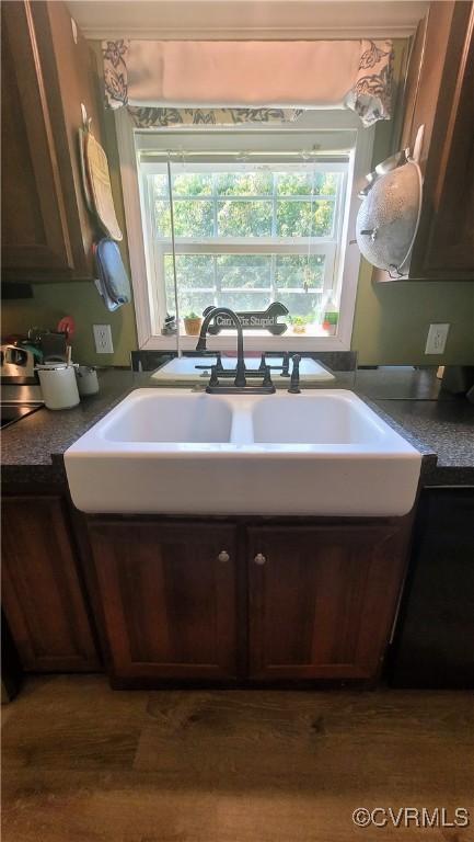 kitchen featuring dark countertops and a sink