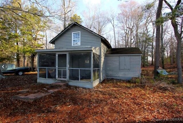 back of property featuring a sunroom